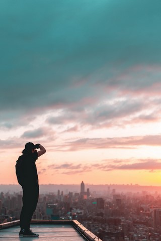 Man looking over cityscape.